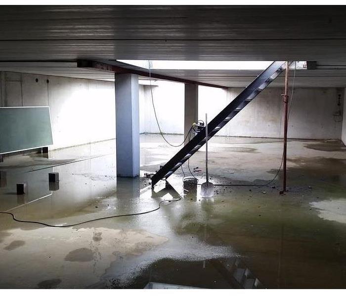 Basement with water damage and standing water.