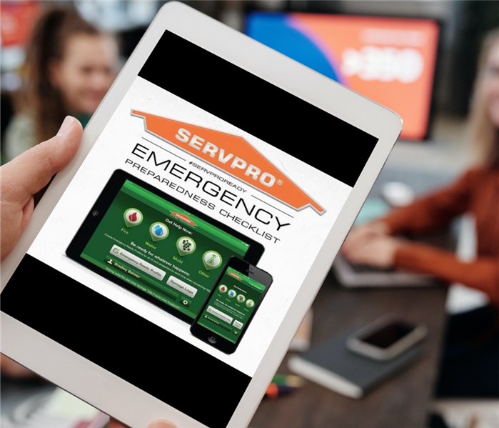 Person holding a tablet with the SERVPRO ERP app on the screen. 